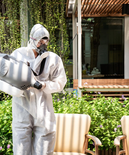 Pest control specialist spraying outdoor area – PC Los Angeles