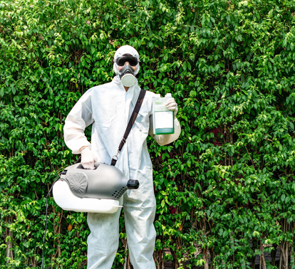 Eco-friendly pest control technician holding spray solution – PC Los Angeles