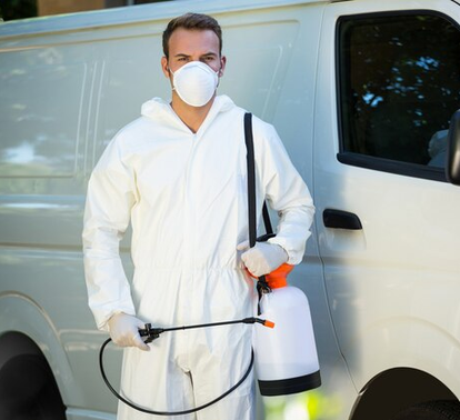 Pest control technician standing with sprayer – PC Los Angeles