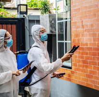 Pest control technicians spraying exterior wall – PC Los Angeles