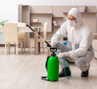 Pest control specialist preparing sprayer for indoor treatment – PC Los Angeles